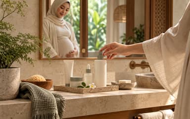 A hand reaching for an unbranded pump bottle on a bathroom counter, a pregnant woman reflected in the mirror behind