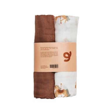 A two-pack of bamboo muslin swaddles rolled together, one rust brown and one printed with carousel horses