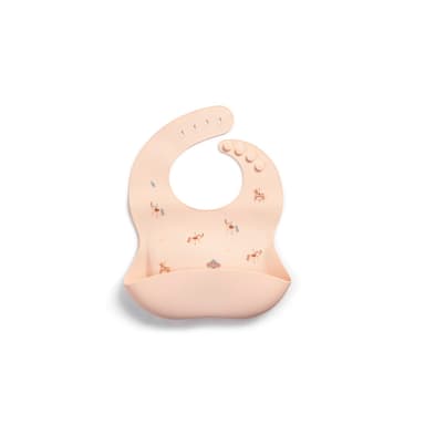 A Little Rei silicone bib in a carousel print with a crumb-catching pocket