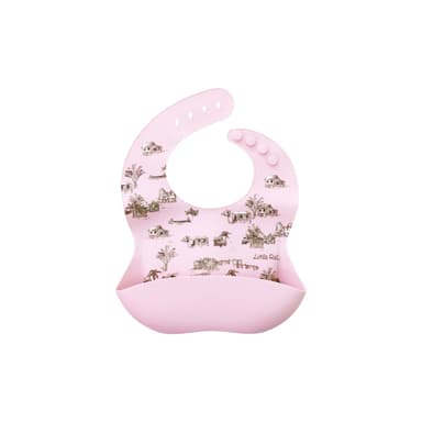 A pale pink silicone baby bib with a crumb pocket, printed with kampong houses and palm trees