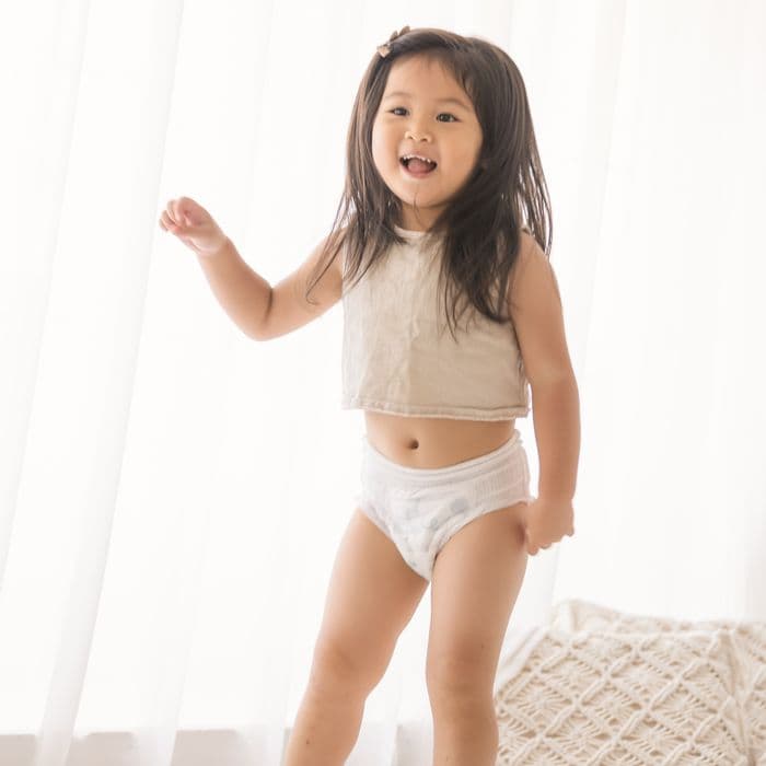A toddler dancing in Little Rei pull-up pants