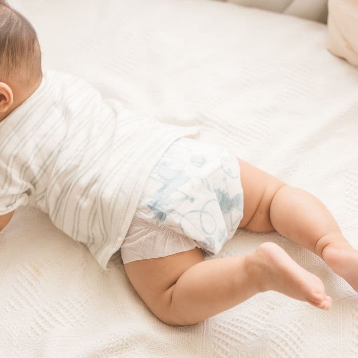 A baby on their tummy in a Little Rei tape diaper