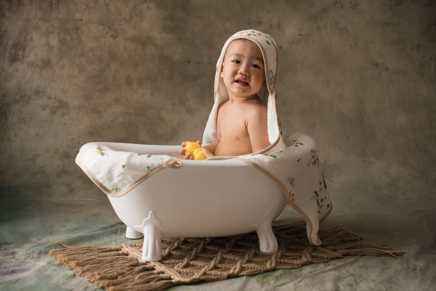 A laughing toddler in a bath, the plain water that cleans a sore diaper area best