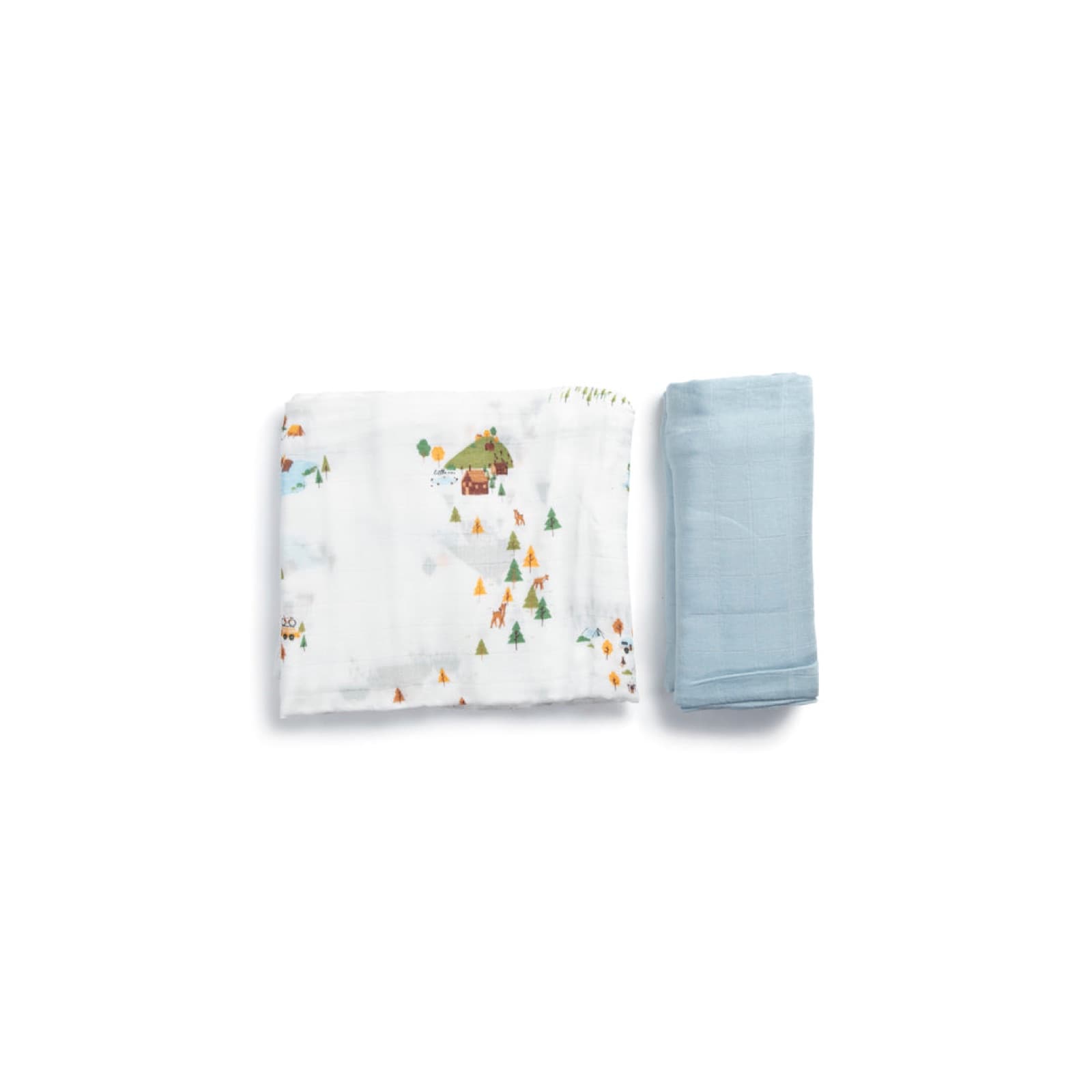 Two folded bamboo muslin swaddles side by side, one printed with a camping scene and one plain pale blue