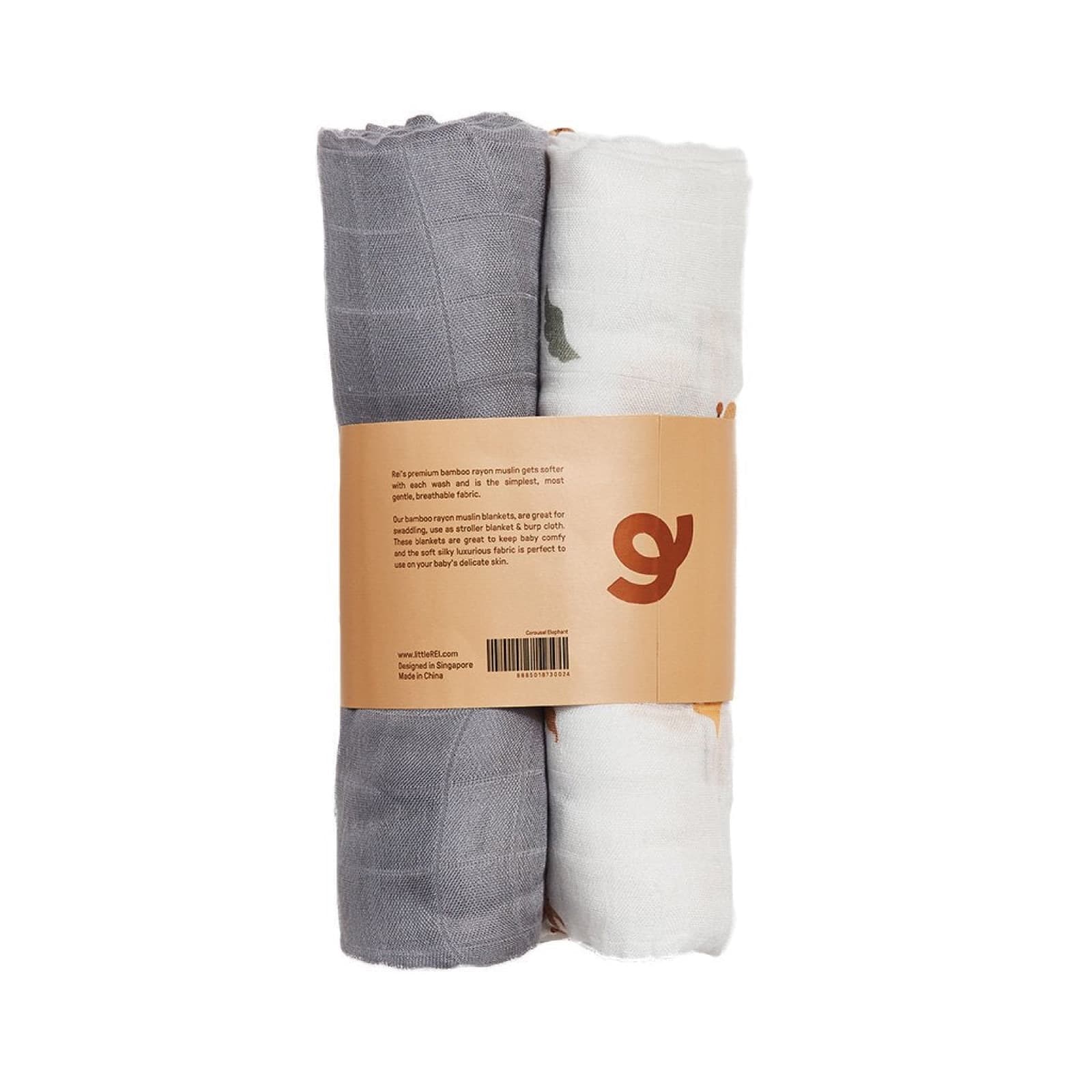 Two rolled bamboo muslin swaddles banded in kraft paper, one grey and one printed with carousel elephants