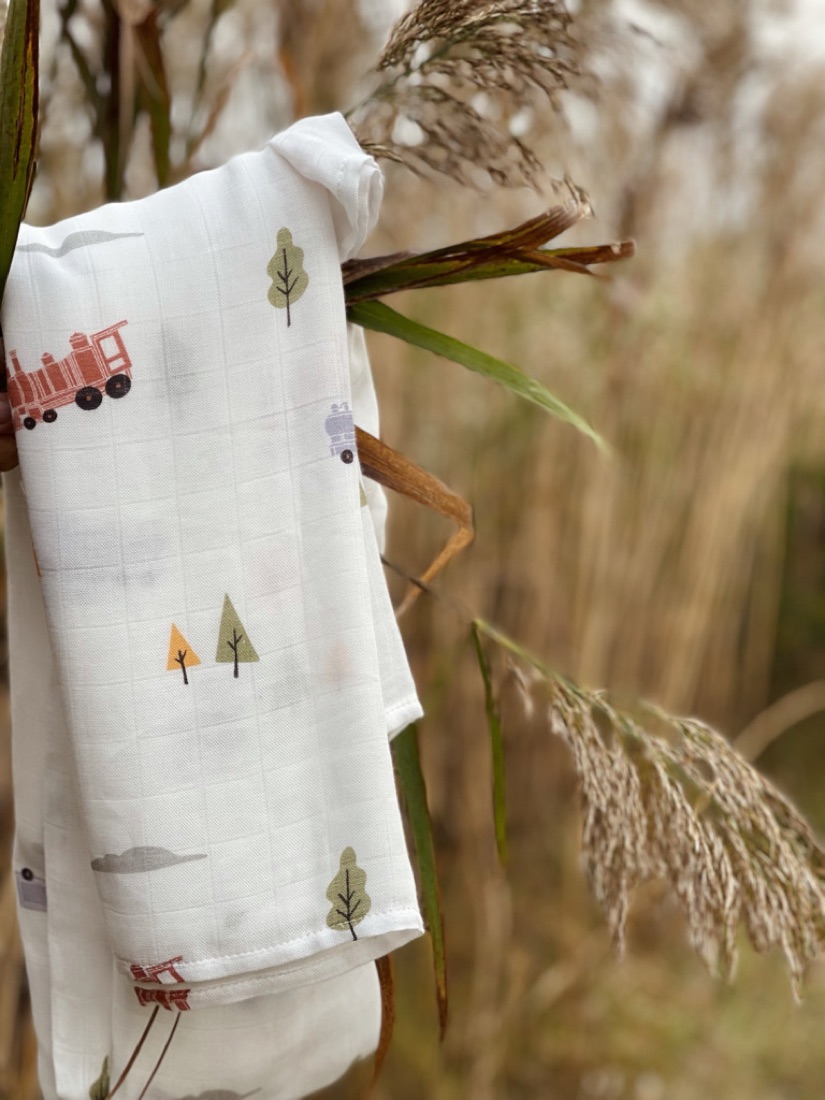 Little Rei swaddle draped over a crib