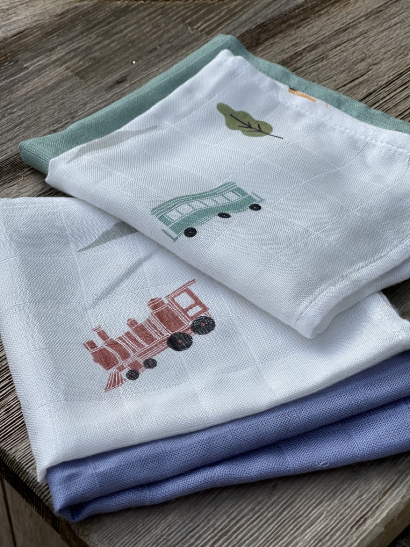 Little Rei swaddle on a balcony overlooking the garden