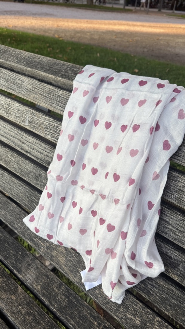 Little Rei hearts swaddle on a picnic bench