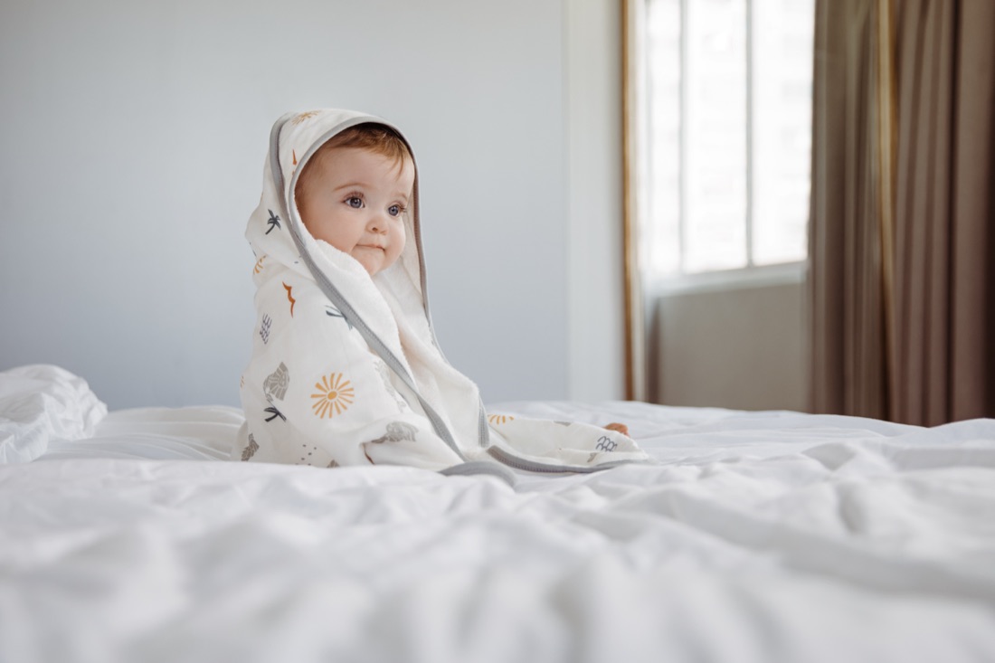 Newborn wrapped in a Little Rei bamboo swaddle